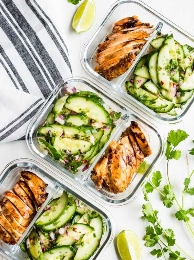 Top view of colorful healthy meal prep boxes, representing nourishment, balance, and intentional eating for energy and strength.