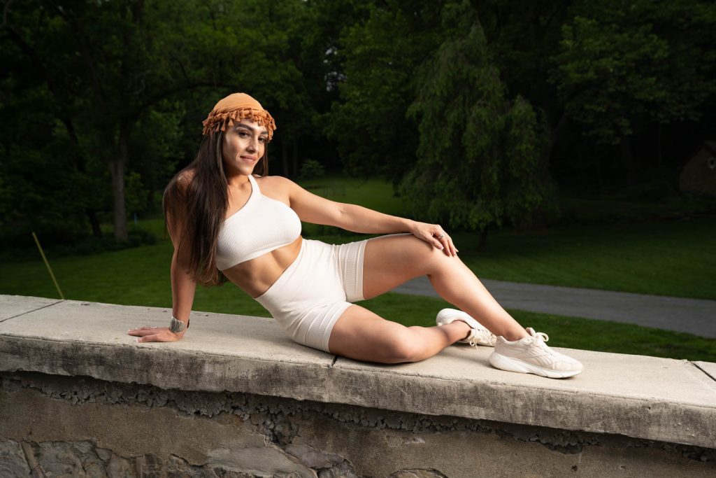 Empowered woman flexing muscles confidently – holistic wellness with CoraZONE